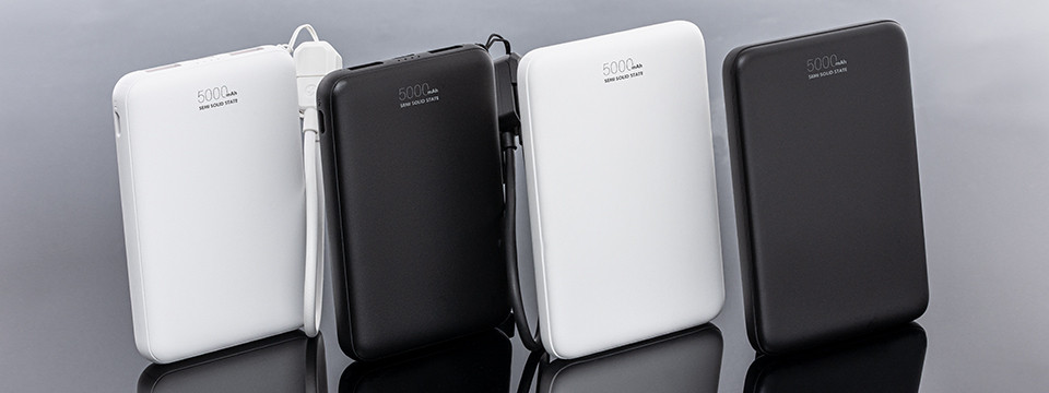 Several black and white power banks displayed in a product lineup on a grey background.