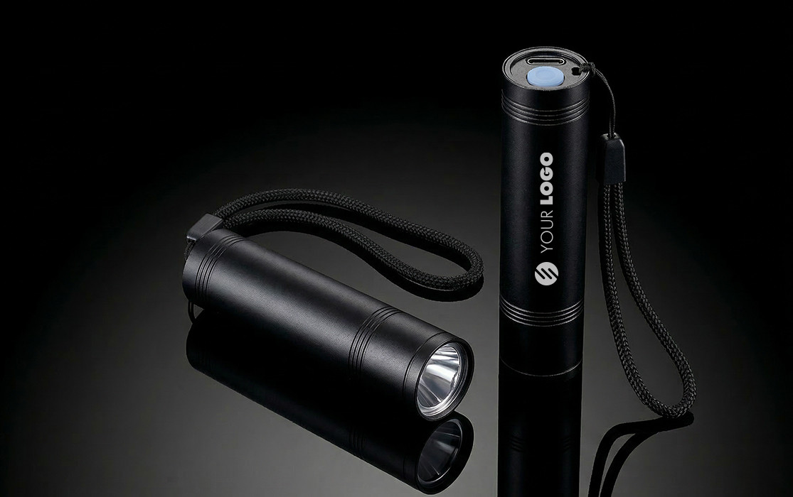 REEVES-FLASH 80 flashlight Two black REEVES-FLASH 80 flashlights with wrist straps on a black reflective surface