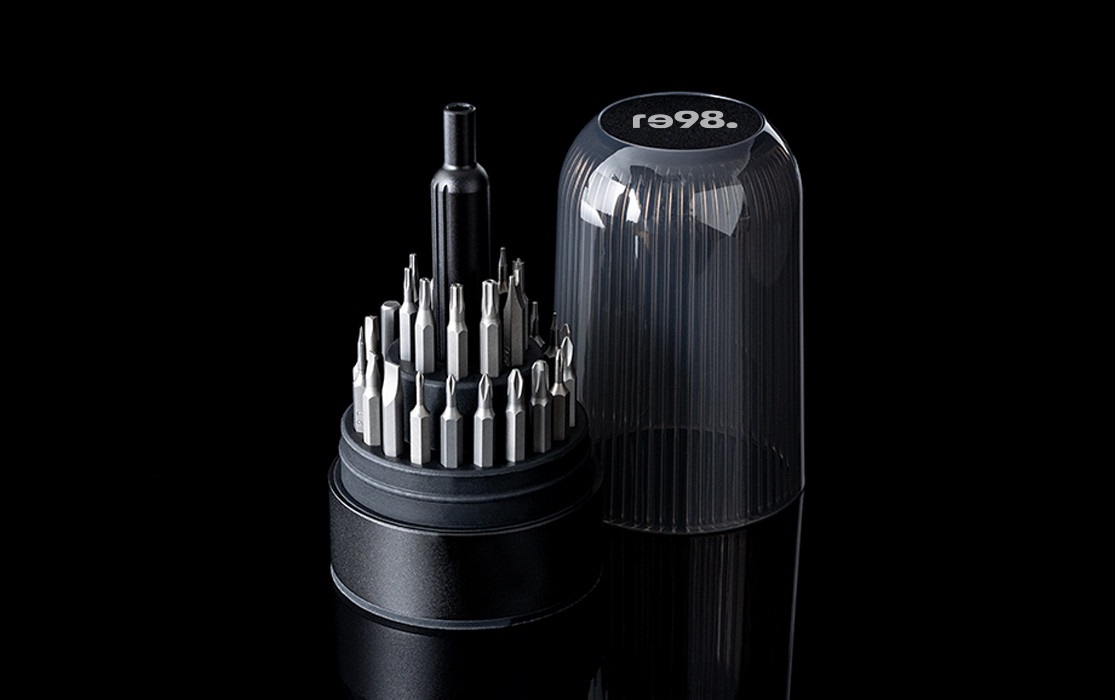 RE98-GRIVIO tool set with various bits and a transparent cover on a black background